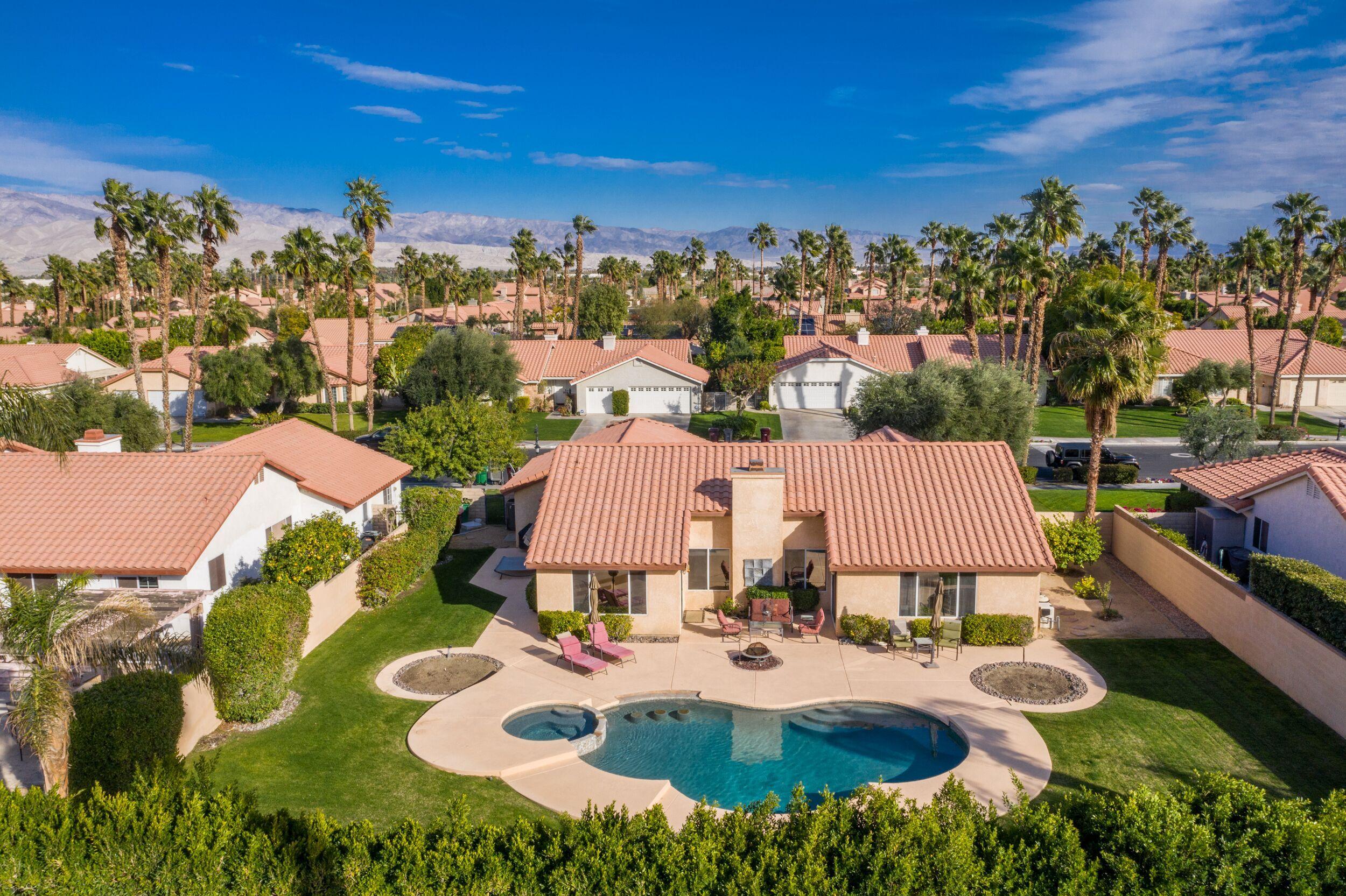 39795 Regency Way Palm Desert, CA 92211 - Photo 5 of 39 a view of a house with pool and chairs
