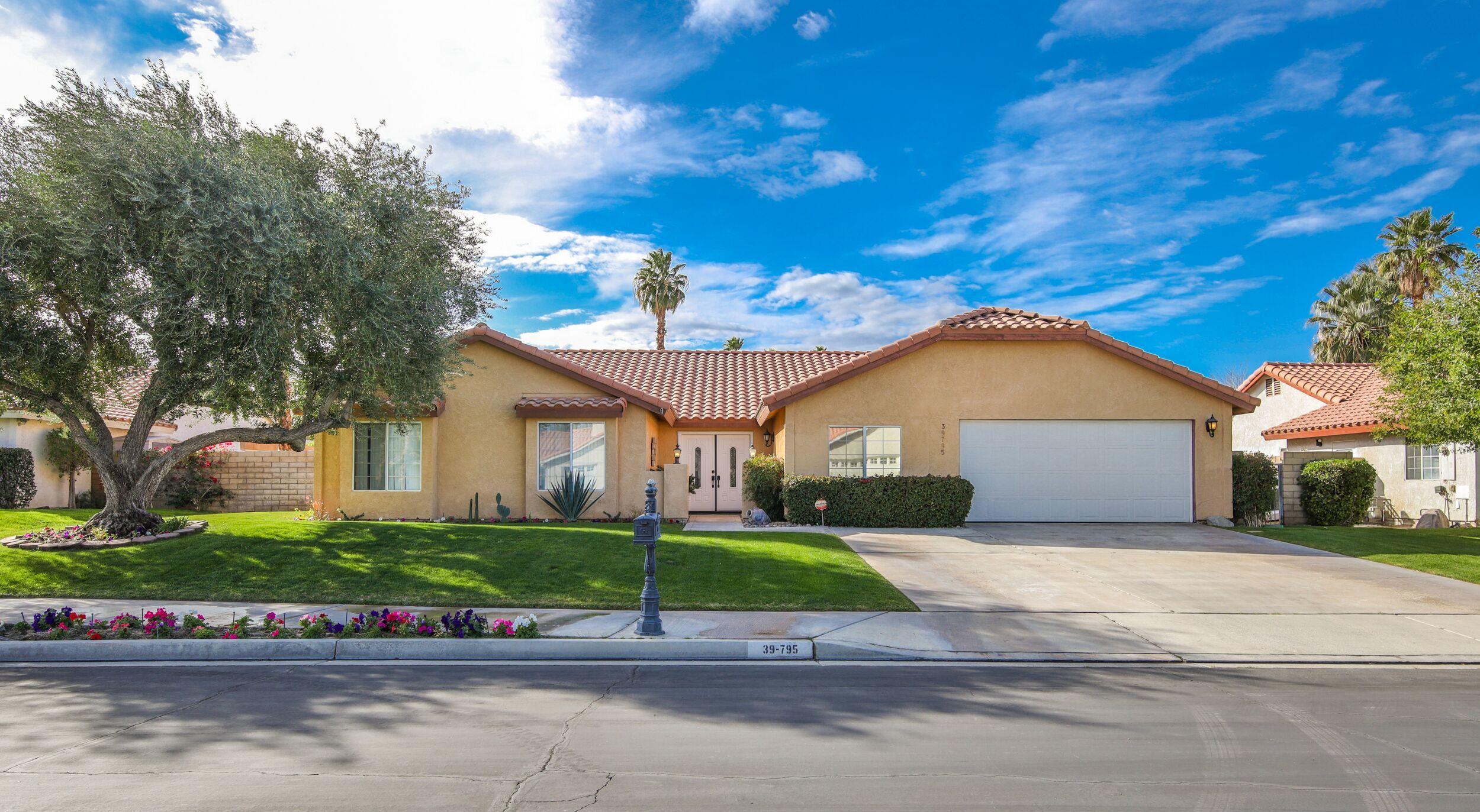 39795 Regency Way Palm Desert, CA 92211 - Photo 8 of 39 a front view of a house with a yard and garage