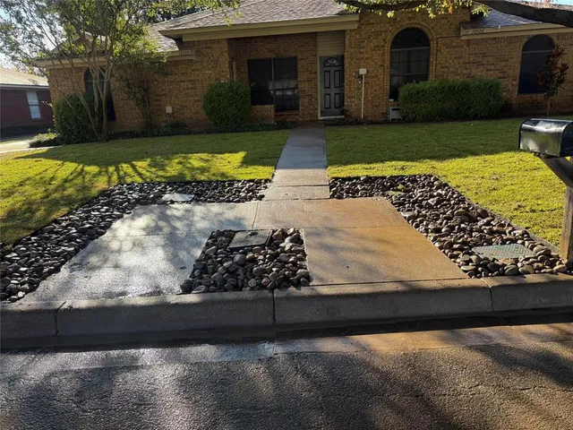 a view of a garden with an outdoor seating