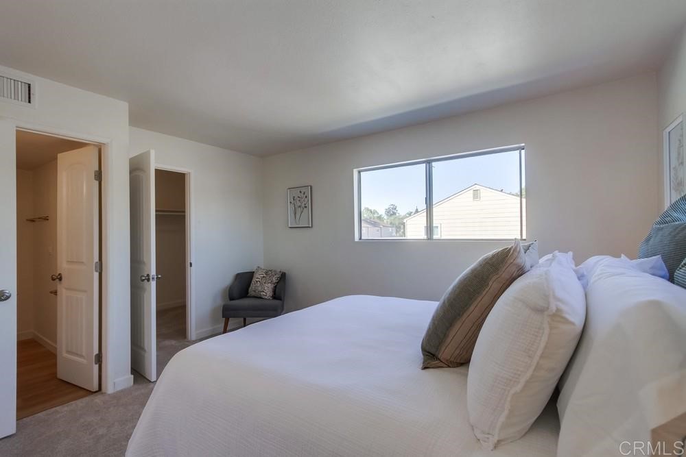 11941 Royal Road, Unit A El Cajon, CA 92021 - Photo 11 of 28 a bedroom with a bed and a window