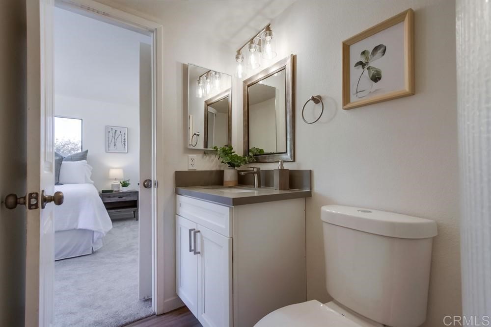 11941 Royal Road, Unit A El Cajon, CA 92021 - Photo 14 of 28 a bathroom with a toilet sink and mirror