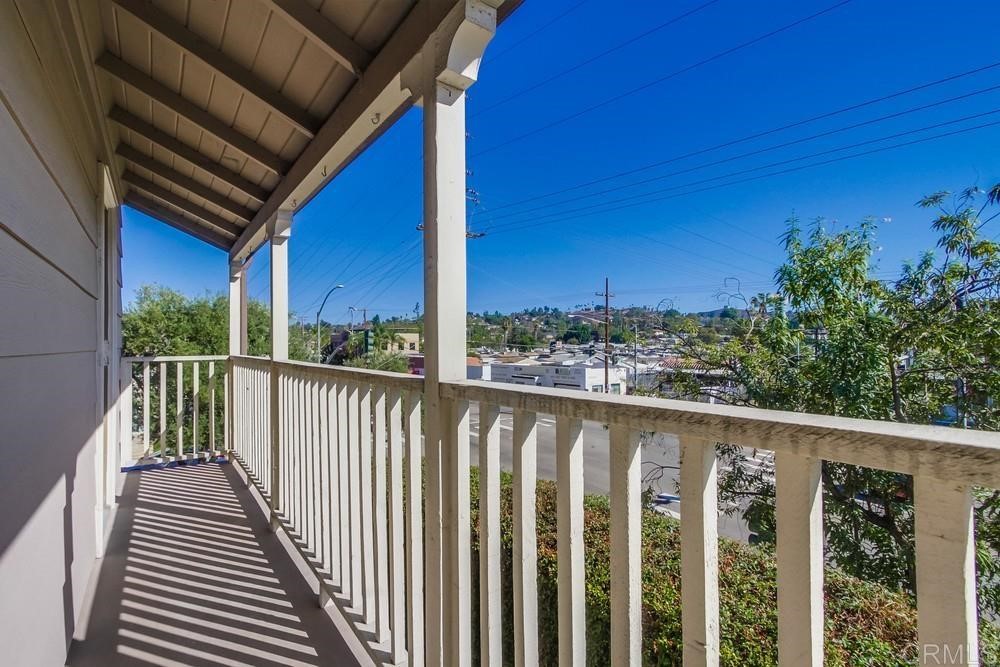 11941 Royal Road, Unit A El Cajon, CA 92021 - Photo 15 of 28 a view of a balcony with wooden floor and fence