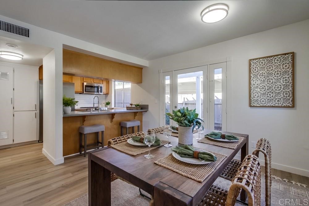 11941 Royal Road, Unit A El Cajon, CA 92021 - Photo 5 of 28 a view of a dining room with furniture and wooden floor