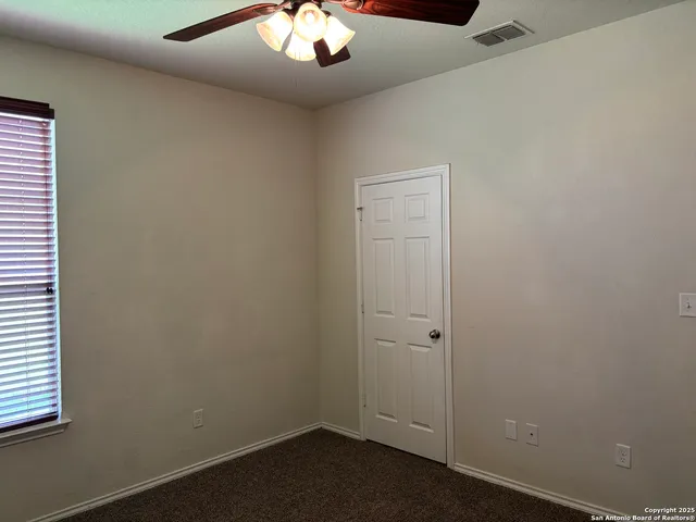 an empty room with a potted plant