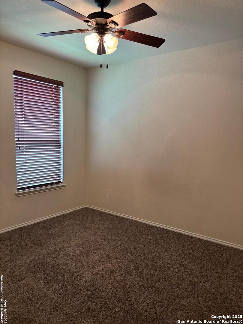3711 Lazy Diamond Schertz, TX 78154 - Photo 15 of 20 an empty room with a window and a fan