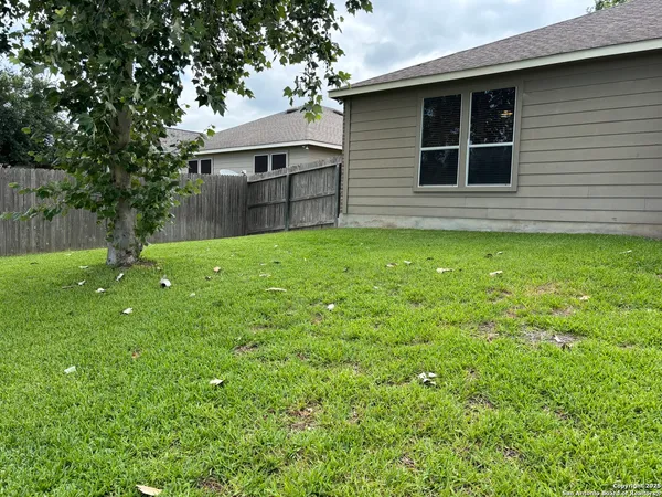 a view of a house with a backyard