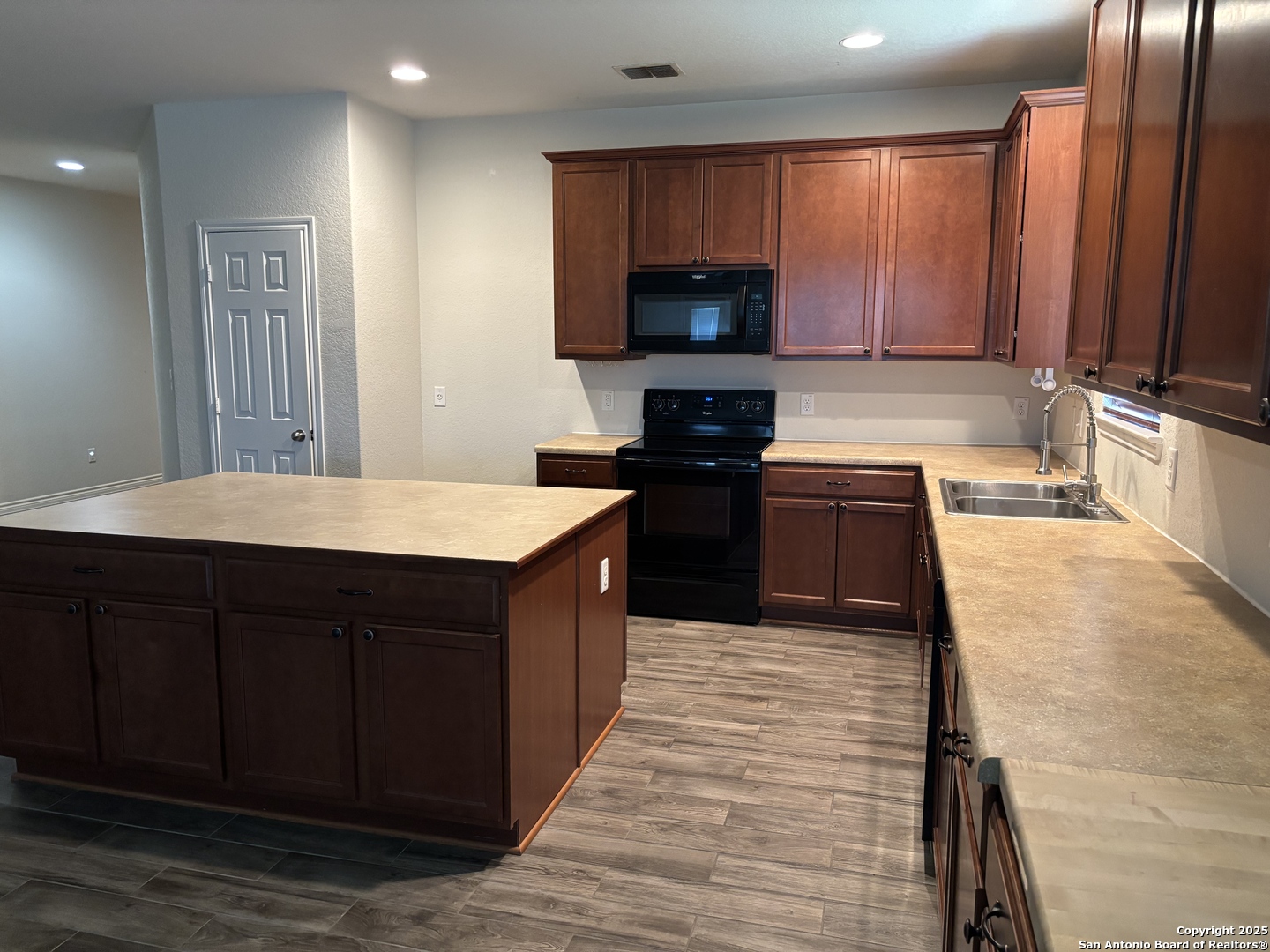 3711 Lazy Diamond Schertz, TX 78154 - Photo 3 of 20 a kitchen with a stove a sink and a microwave