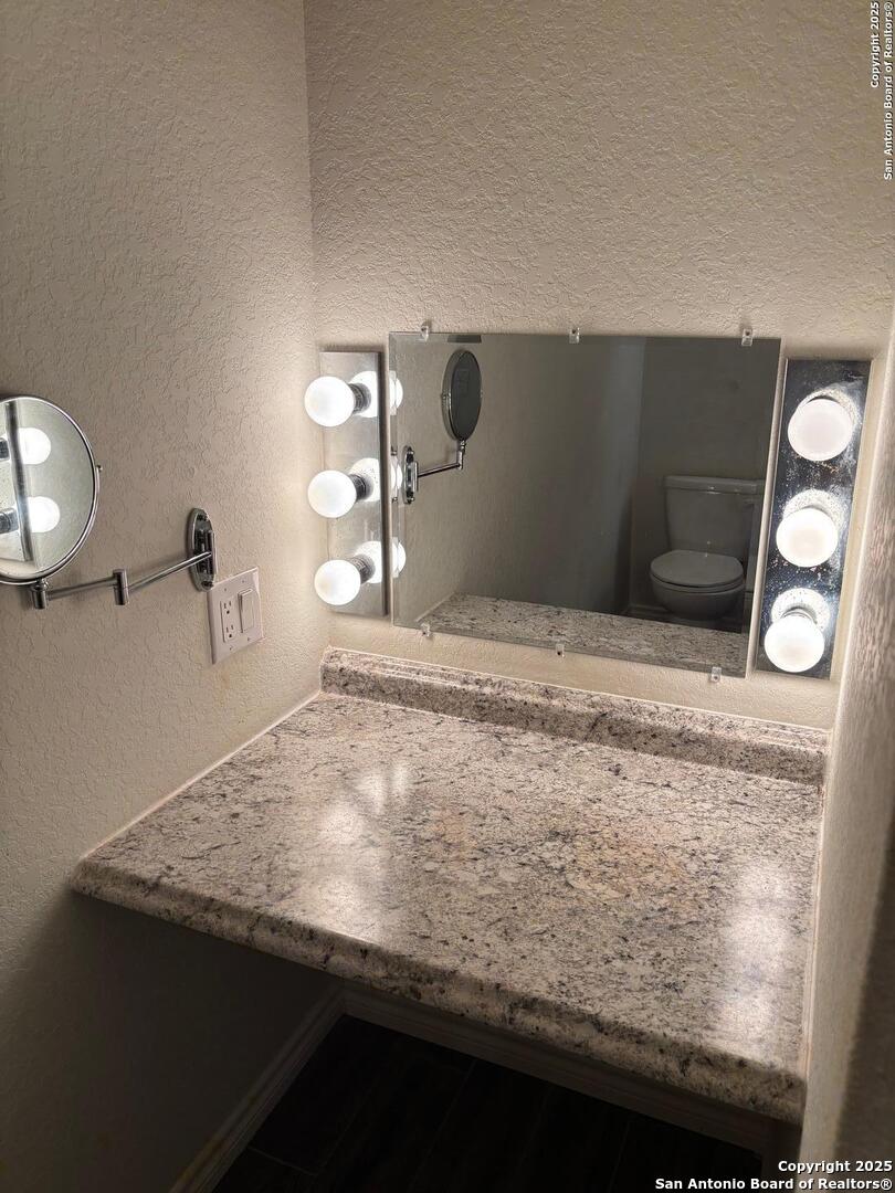 3711 Lazy Diamond Schertz, TX 78154 - Photo 8 of 20 a bathroom with a granite countertop sink and vanity