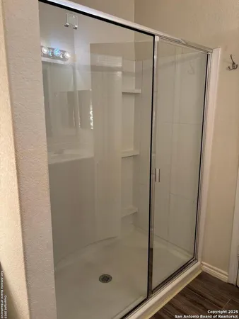 a bathroom with a glass shower door