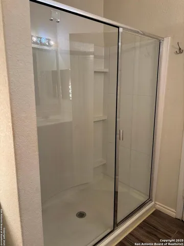 a bathroom with a glass shower door