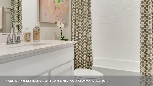 a bathroom with a shower curtain and a sink