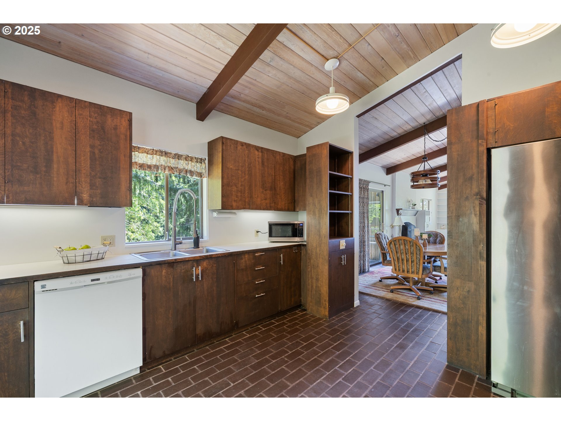 56100 High Point Road Otis, OR 97368 - Photo 19 of 47 a kitchen with wooden floors and wooden cabinets