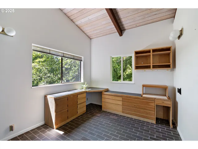 a dining room with furniture and a floor to ceiling window