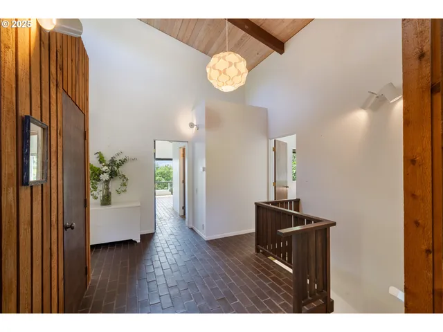 a view of an entryway with wooden floor