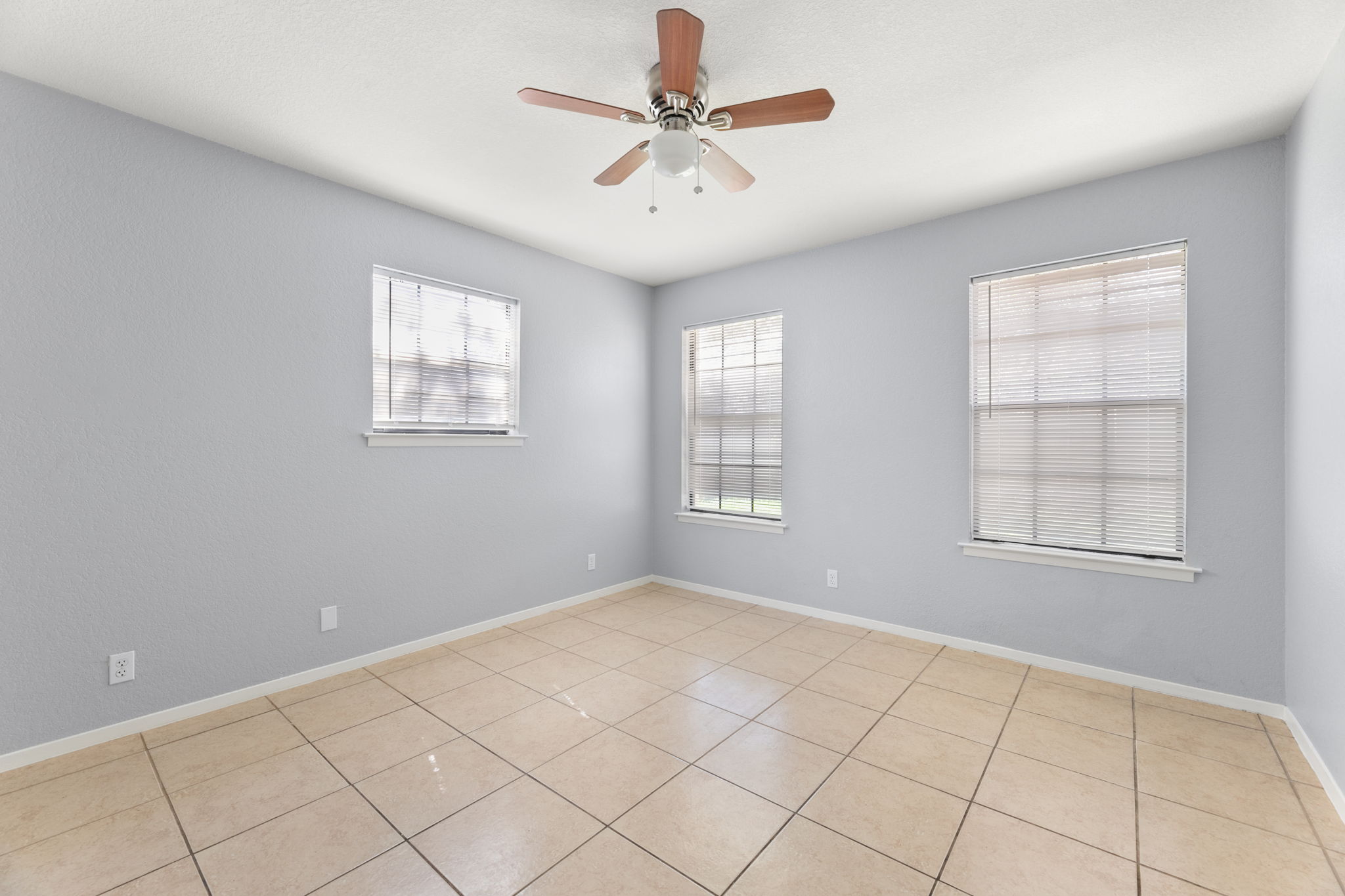 3802 Foust Trail, Unit A Georgetown, TX 78628 - Photo 18 of 34 Well-lit room featuring tile flooring and a ceiling fan for optimal comfort.