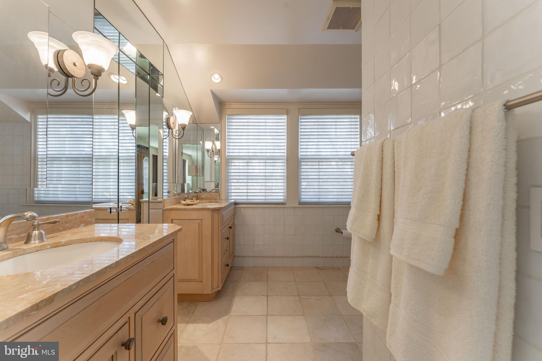 249 Bell Road Wynnewood, PA 19096 - Photo 37 of 76 a bathroom with a sink a vanity a mirror and a bathtub