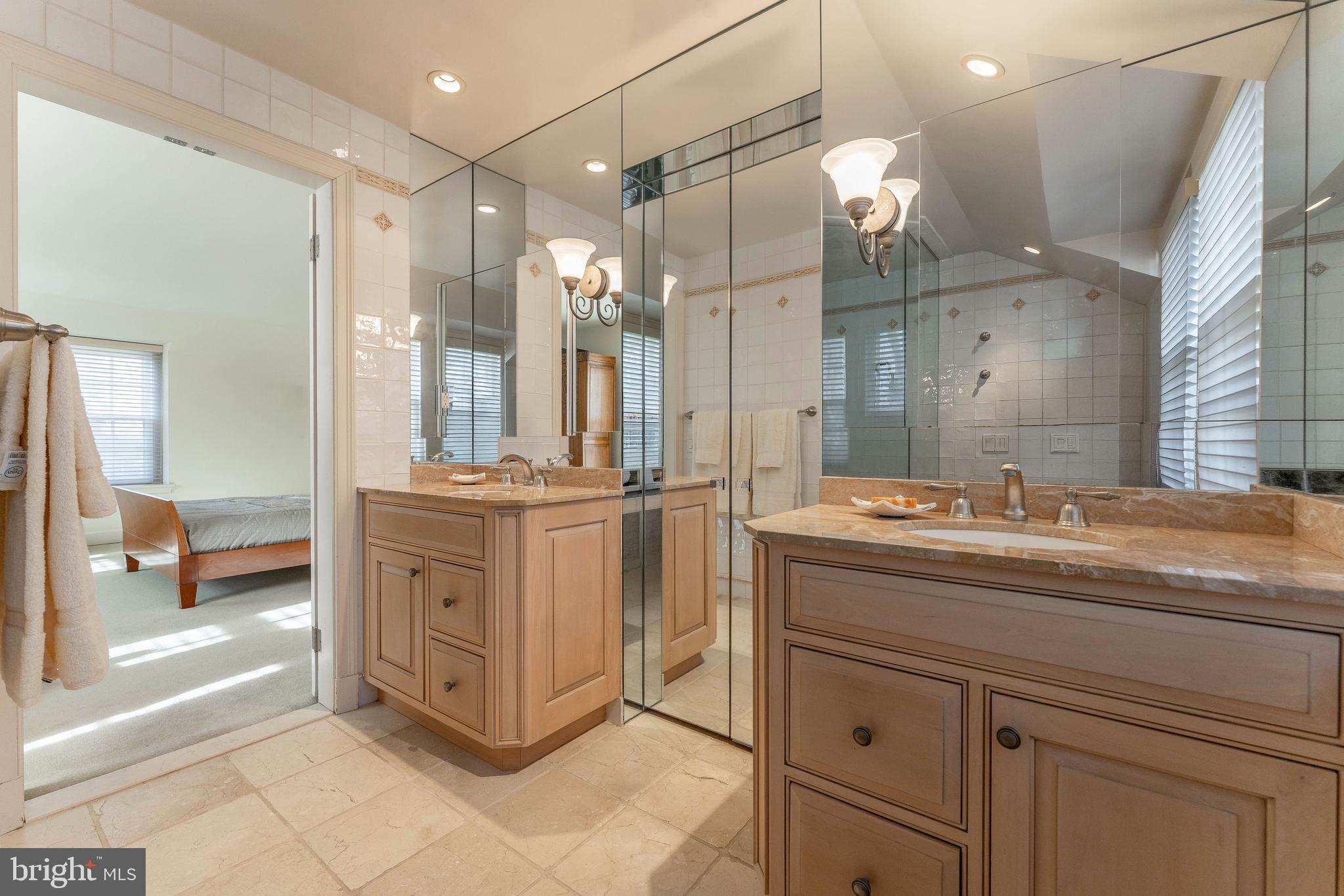249 Bell Road Wynnewood, PA 19096 - Photo 39 of 76 a bathroom with a granite countertop sink a large mirror and a shower