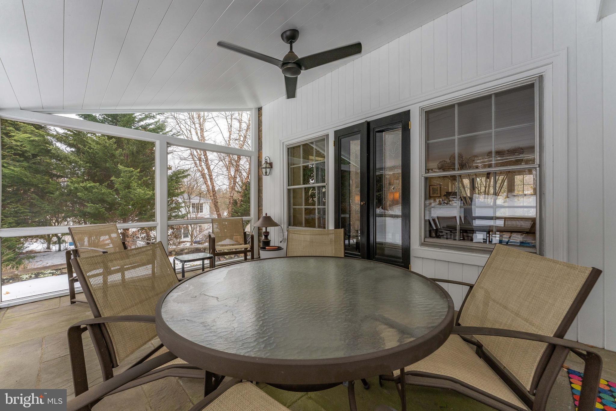 249 Bell Road Wynnewood, PA 19096 - Photo 59 of 76 a dining room with furniture large windows and a chandelier