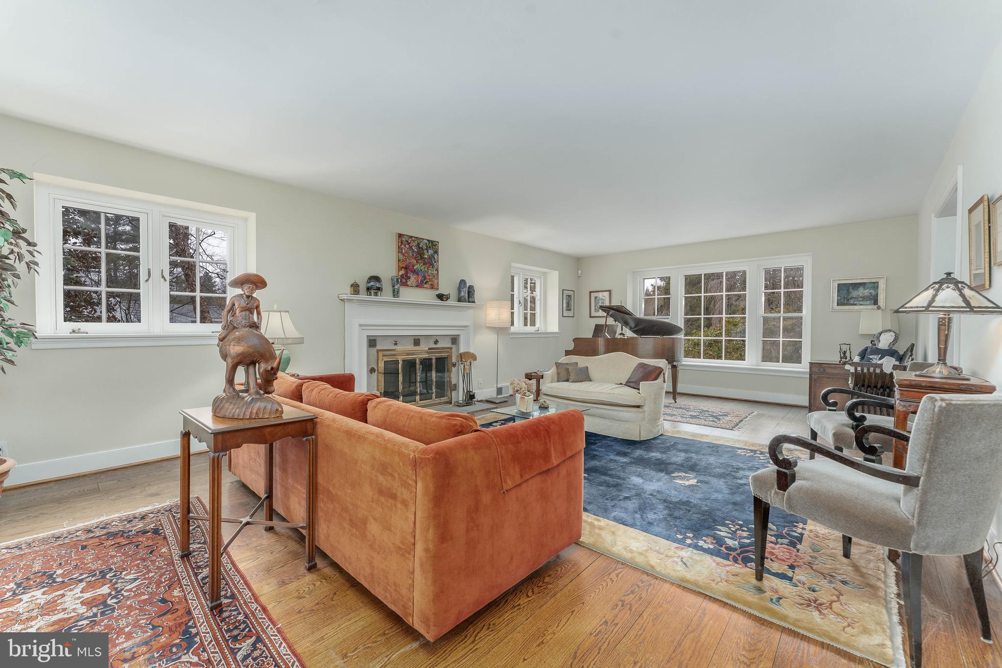 249 Bell Road Wynnewood, PA 19096 - Photo 10 of 76 a living room with furniture a fireplace and a large window