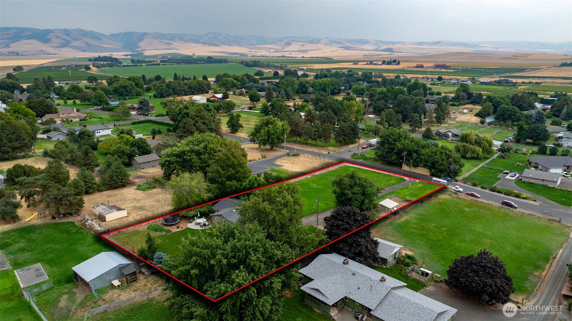 371 Hill Road Walla Walla, WA 99362 - Photo 13 of 40 an aerial view of green landscape with trees houses and mountain view