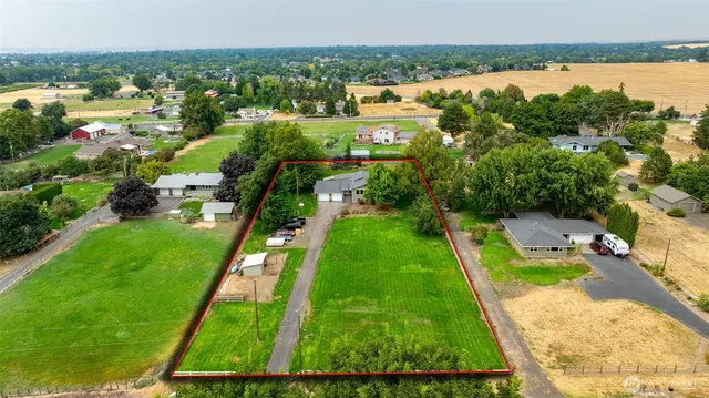 an aerial view of residential houses with outdoor space and swimming pool