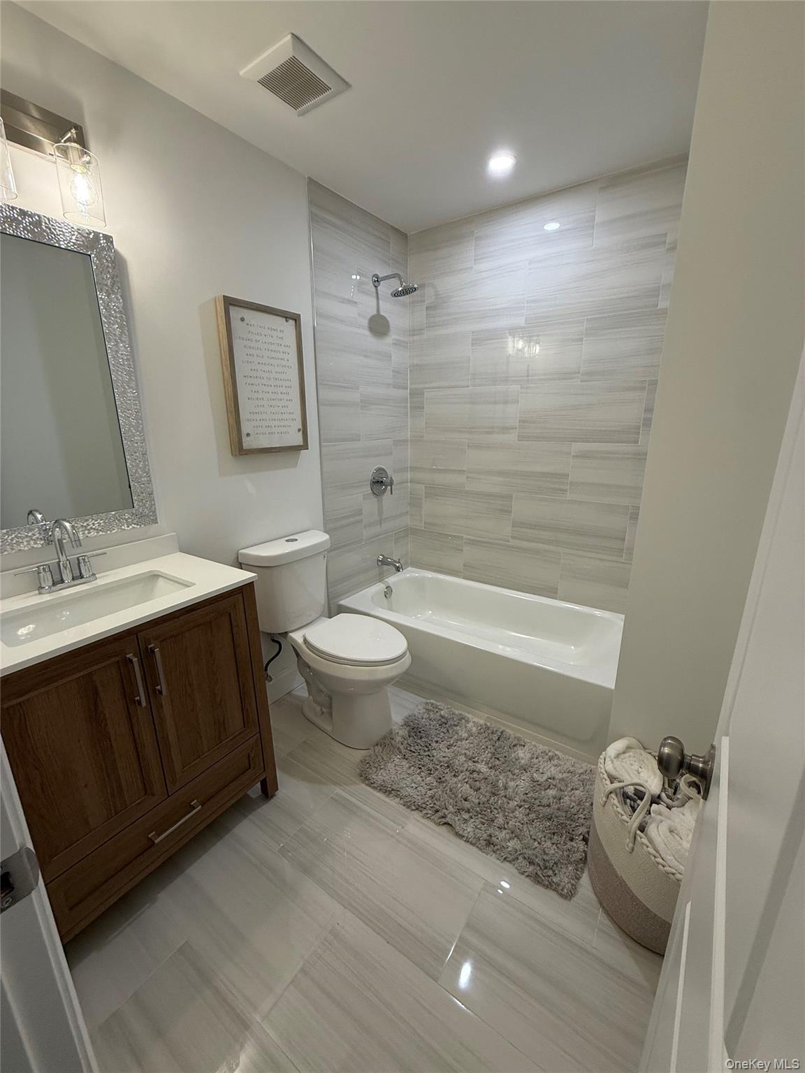 661 College Road Farmingville, NY 11738 - Photo 11 of 19 Bathroom featuring vanity and tub / shower combination