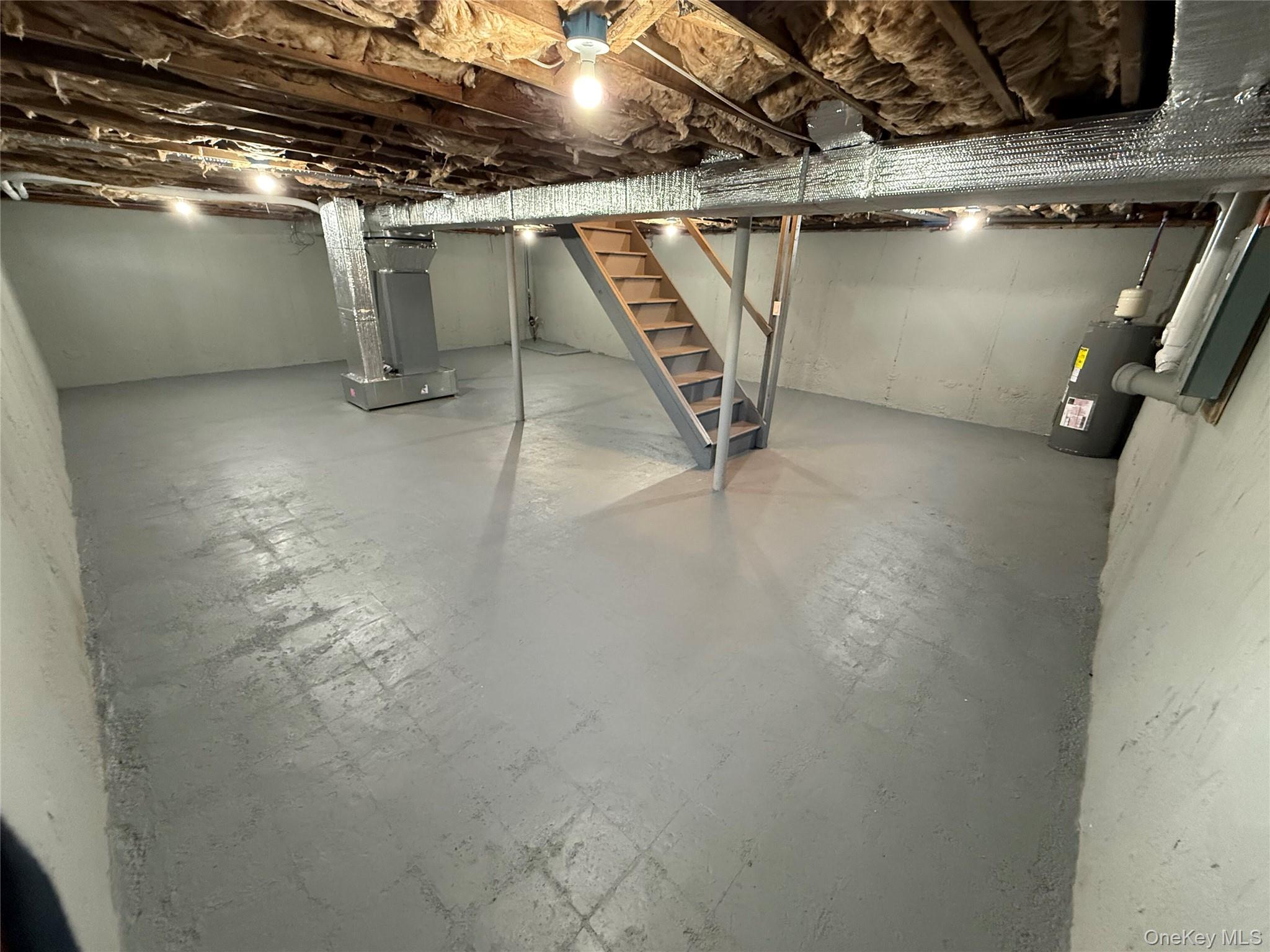 661 College Road Farmingville, NY 11738 - Photo 12 of 19 Unfinished basement with electric water heater and heating unit