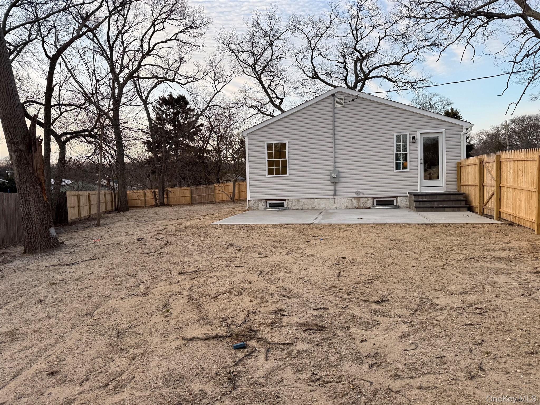 661 College Road Farmingville, NY 11738 - Photo 14 of 19 Rear view of property with a patio area, a fenced backyard, and entry steps