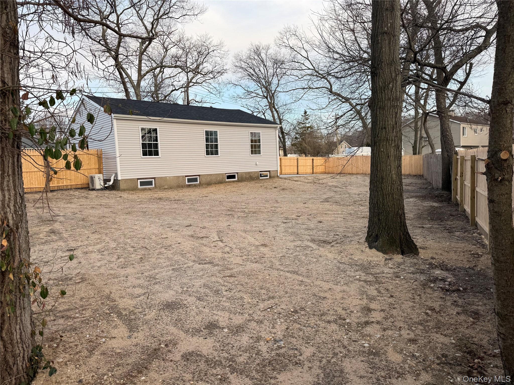 661 College Road Farmingville, NY 11738 - Photo 16 of 19 Rear view of house featuring a fenced backyard