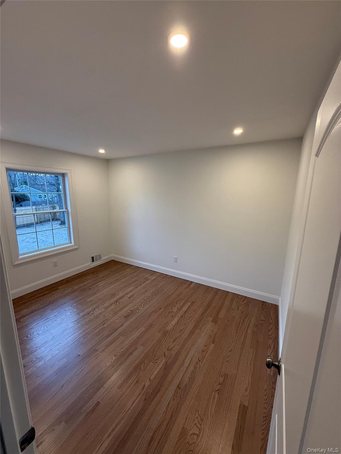 661 College Road Farmingville, NY 11738 - Photo 6 of 19 Spare room featuring dark wood-style flooring and recessed lighting