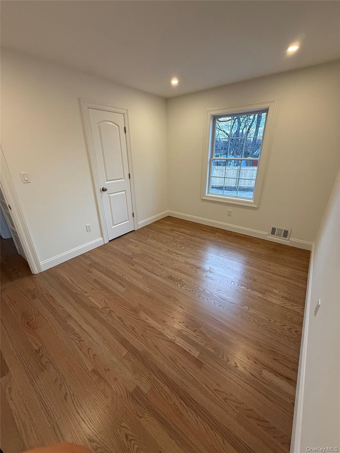661 College Road Farmingville, NY 11738 - Photo 7 of 19 Spare room with dark wood finished floors and recessed lighting