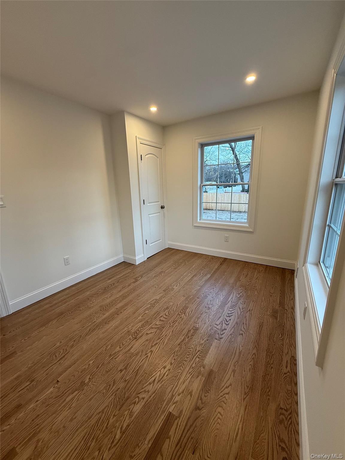 661 College Road Farmingville, NY 11738 - Photo 10 of 19 Spare room featuring dark wood finished floors and recessed lighting