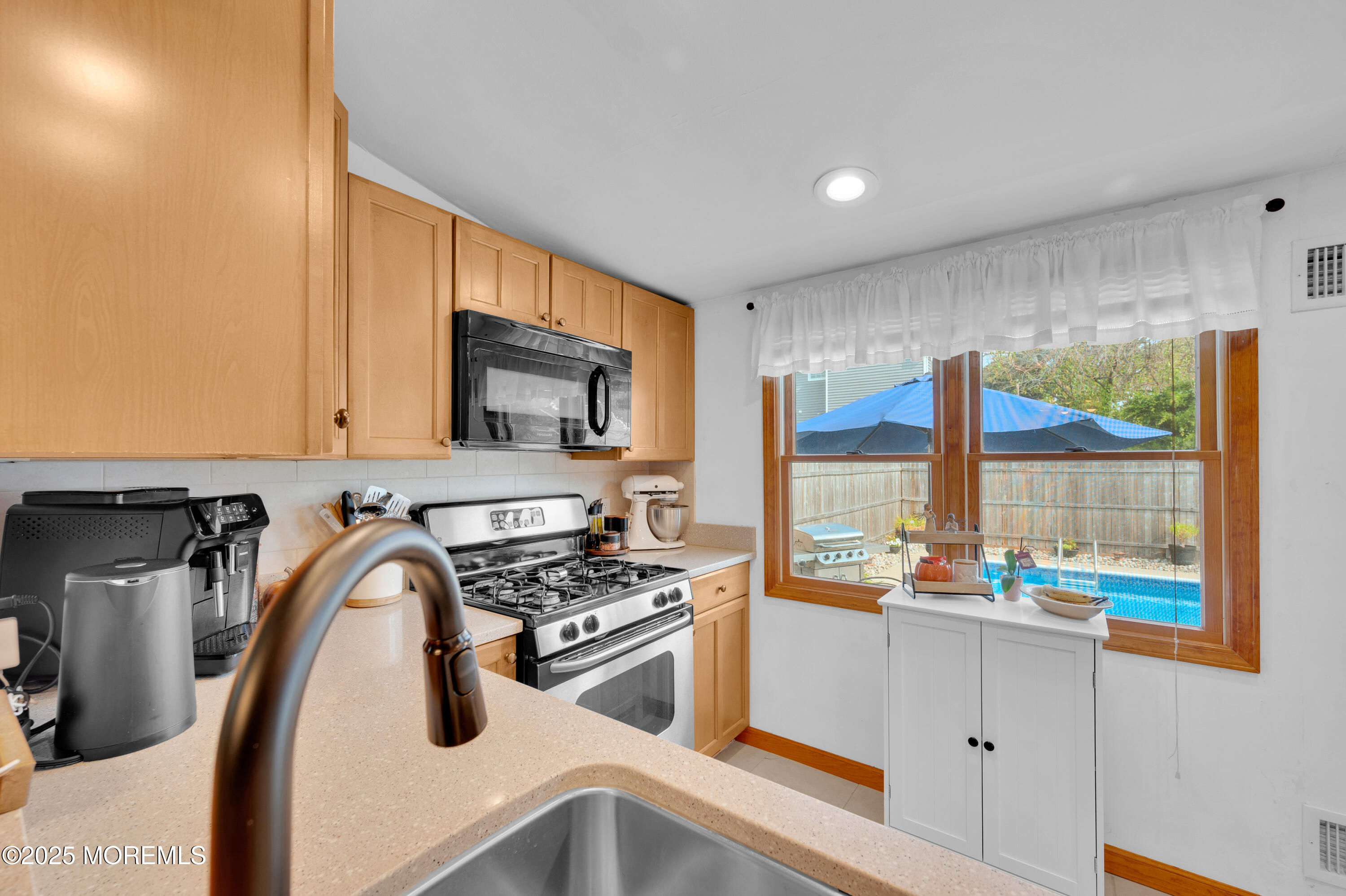 2121 Foster Road Point Pleasant, NJ 08742 - Photo 15 of 47 a kitchen with stainless steel appliances a sink a stove and a refrigerator