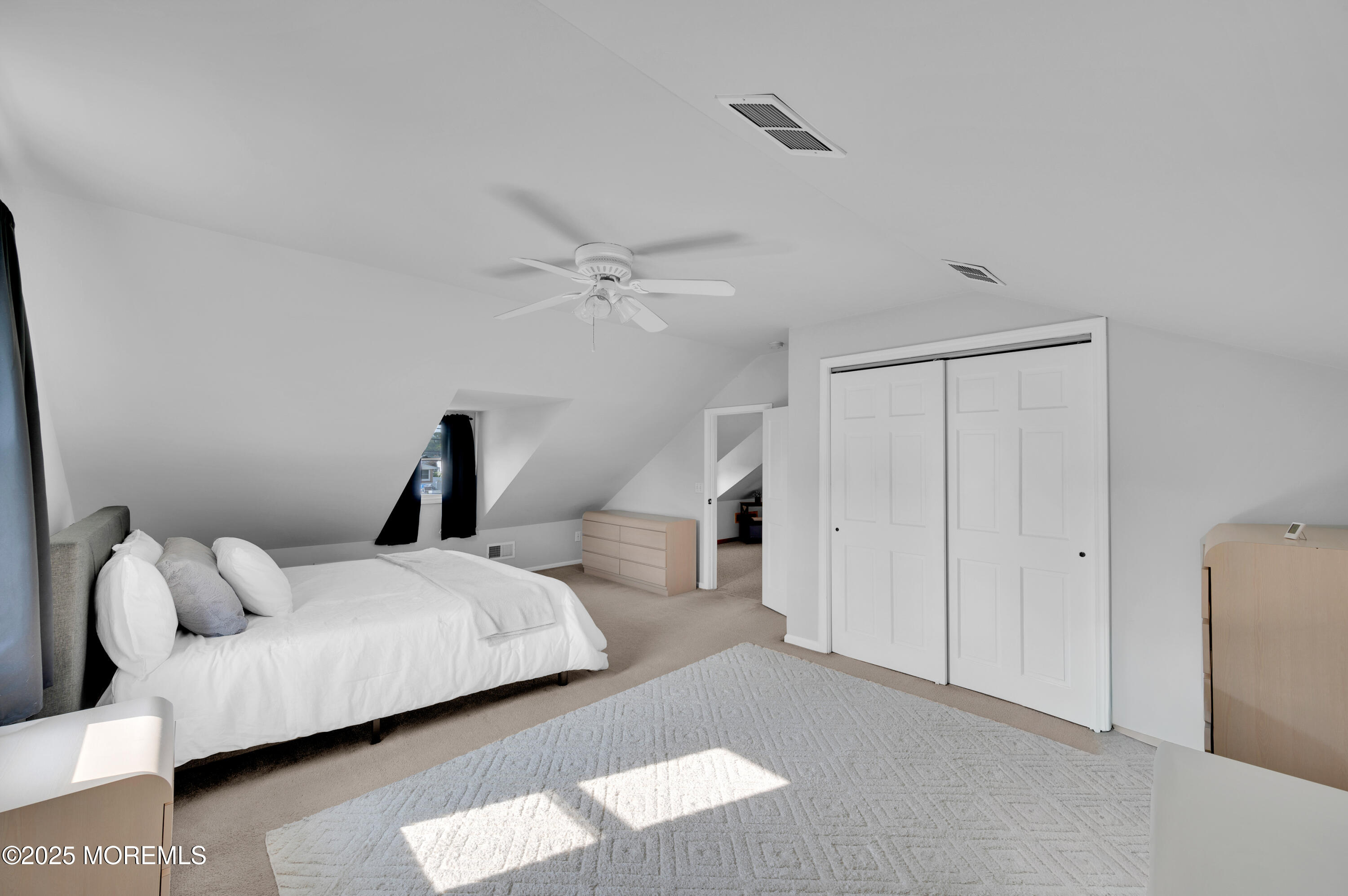 2121 Foster Road Point Pleasant, NJ 08742 - Photo 27 of 47 a bedroom with a bed and a chandelier