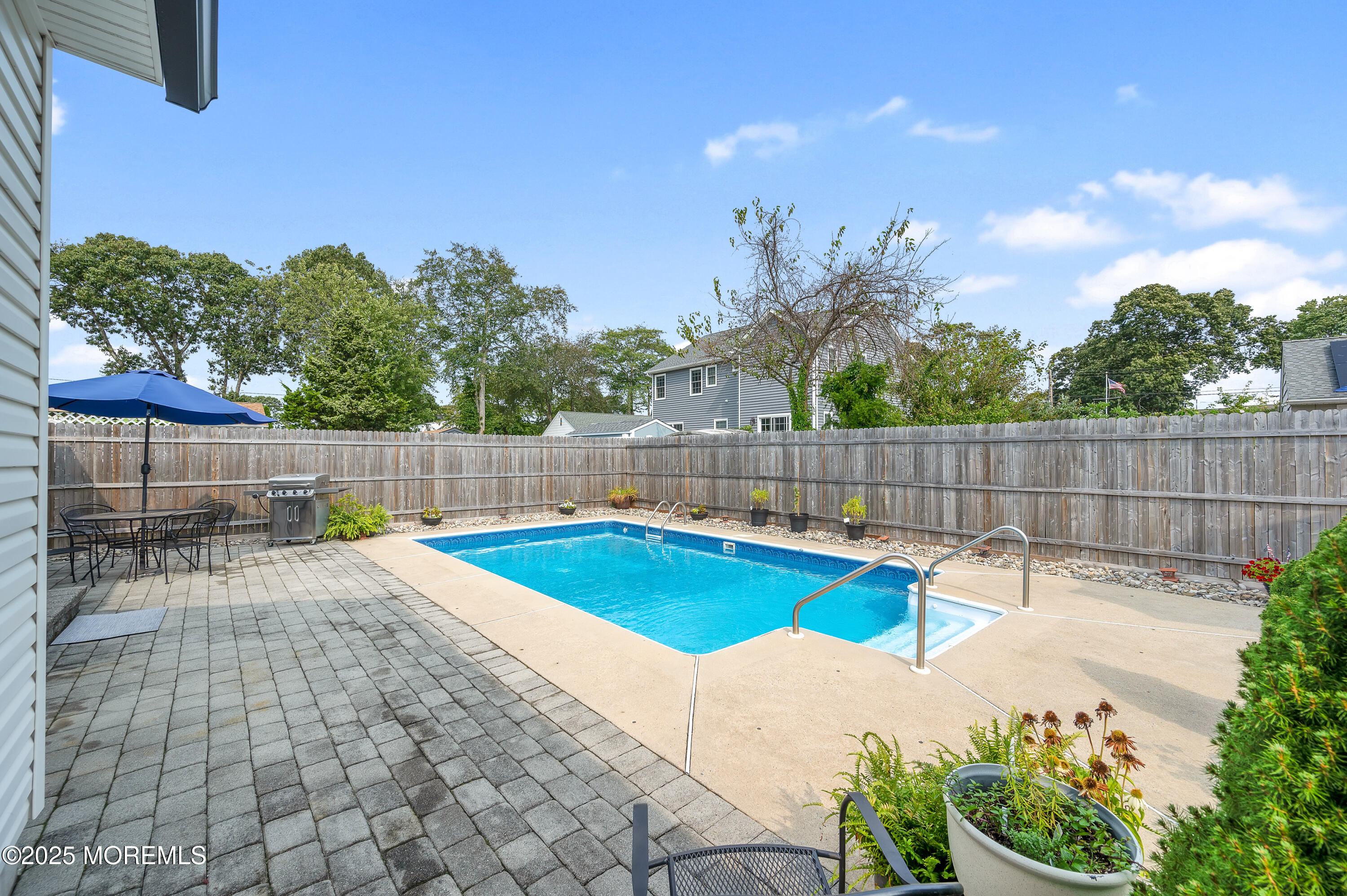 2121 Foster Road Point Pleasant, NJ 08742 - Photo 38 of 47 a view of backyard with swimming pool and outdoor seating