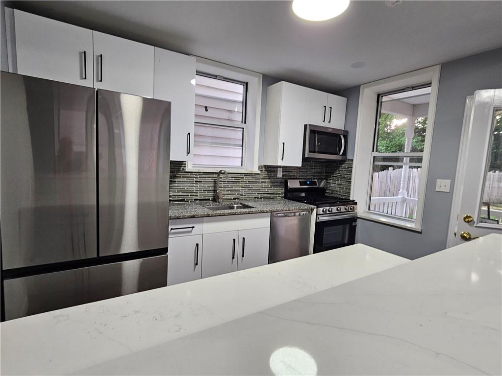 516 Jackson Street Rochester, PA 15074 - Photo 15 of 30 a kitchen with a refrigerator stove and microwave