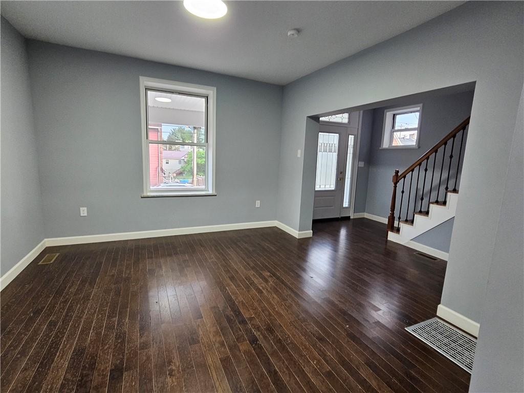 516 Jackson Street Rochester, PA 15074 - Photo 16 of 30 a view of an empty room with wooden floor and a window
