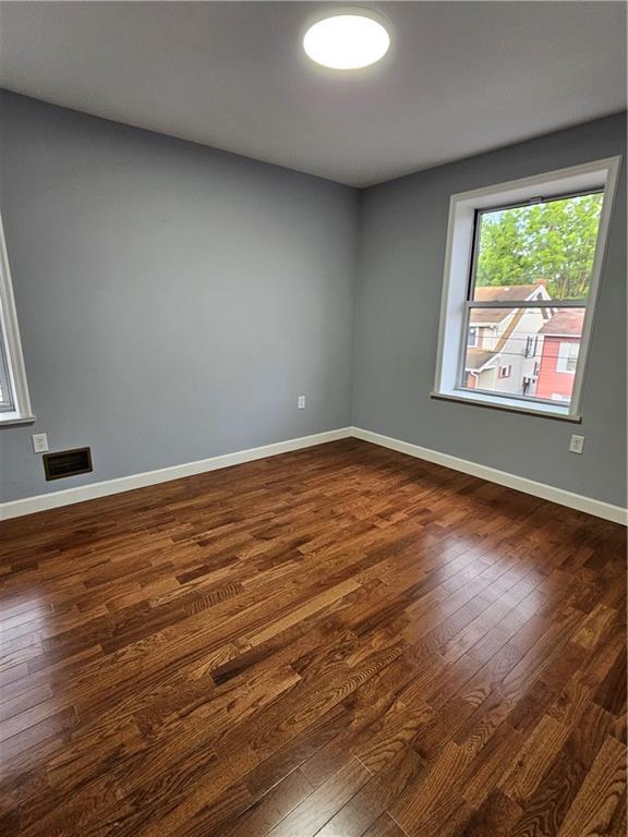 516 Jackson Street Rochester, PA 15074 - Photo 23 of 30 a view of an empty room with wooden floor and a window