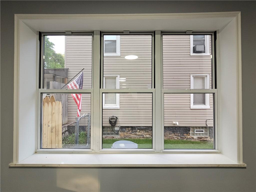 516 Jackson Street Rochester, PA 15074 - Photo 10 of 30 a view of a house with a window and a small yard