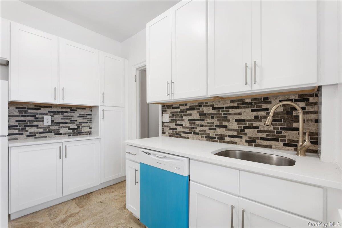 45 Popham Road, Unit 1E Scarsdale, NY 10583 - Photo 11 of 24 a kitchen with a sink and cabinets