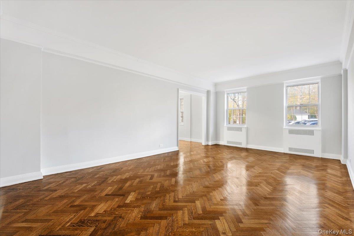 45 Popham Road, Unit 1E Scarsdale, NY 10583 - Photo 5 of 24 a view of an empty room with wooden floor and a window