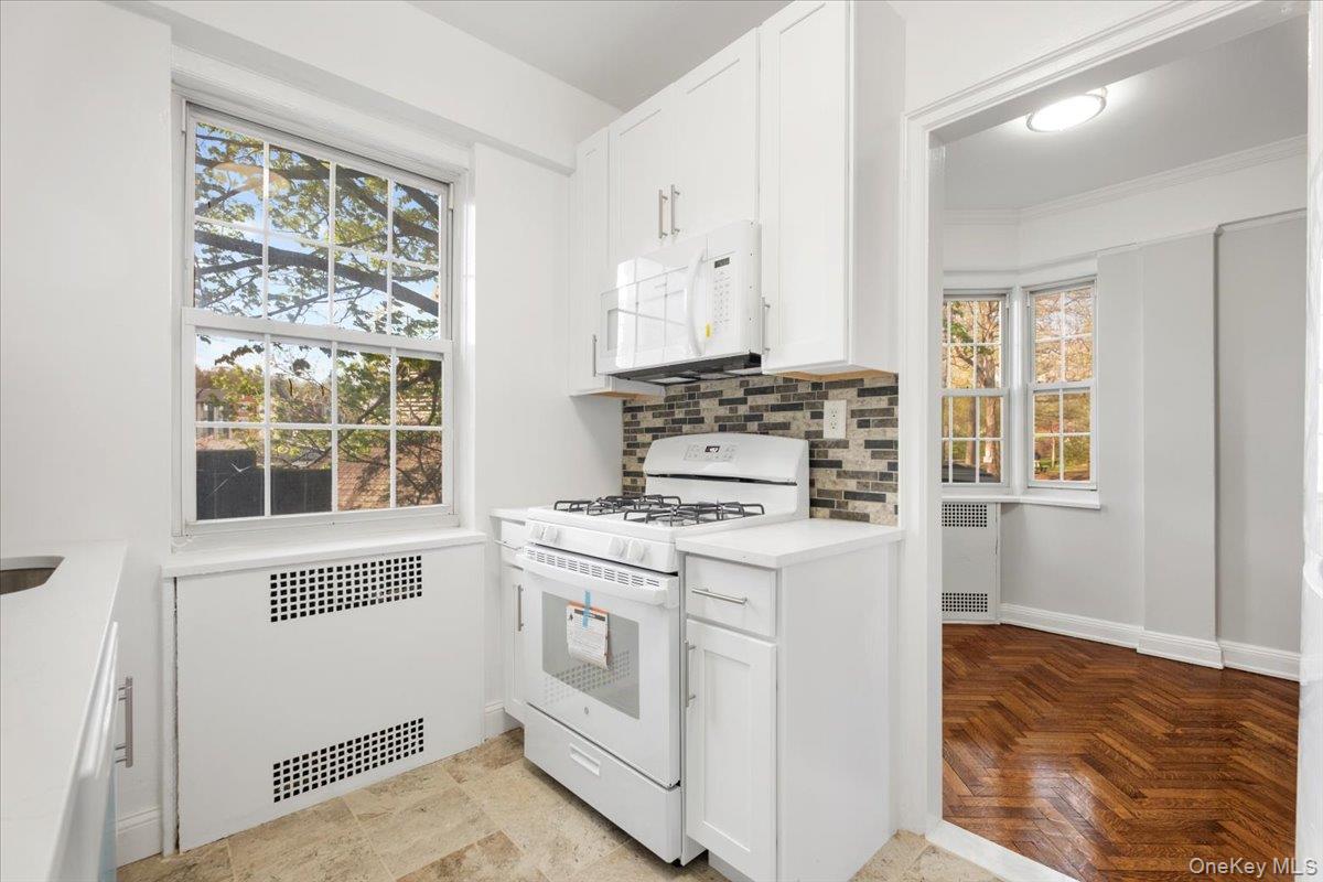 45 Popham Road, Unit 1E Scarsdale, NY 10583 - Photo 9 of 24 a kitchen with a stove a sink and a refrigerator