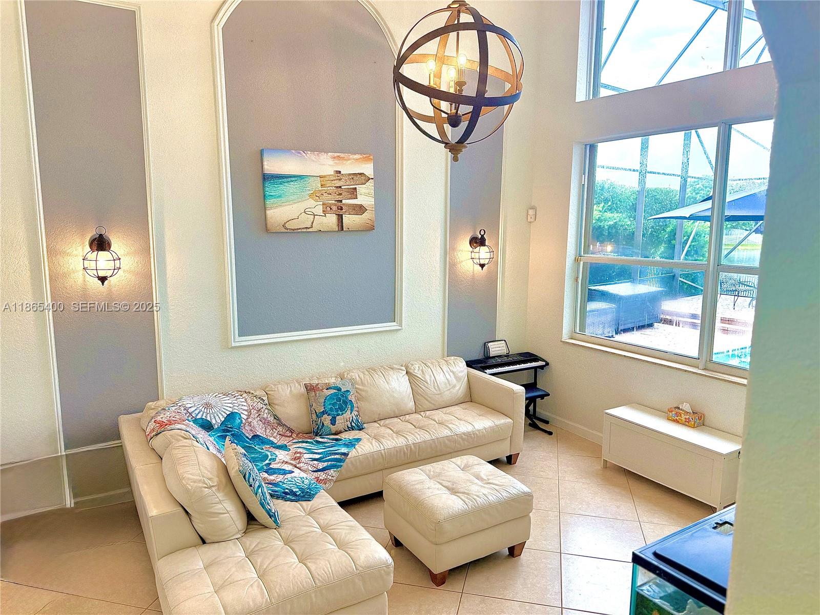 18991 Southwest 32nd Street Miramar, FL 33029 - Photo 13 of 98 a living room with furniture and a large window