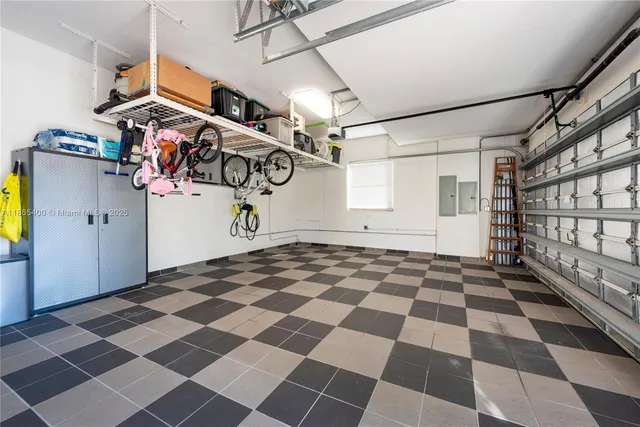 an aerial view of ocean and residential houses with outdoor space