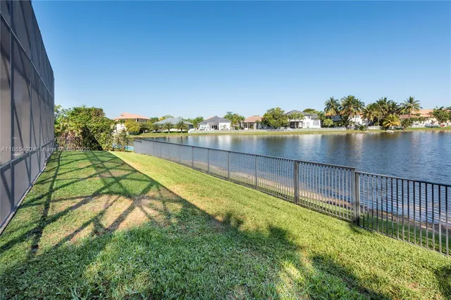 a view of a park with of a house in the background