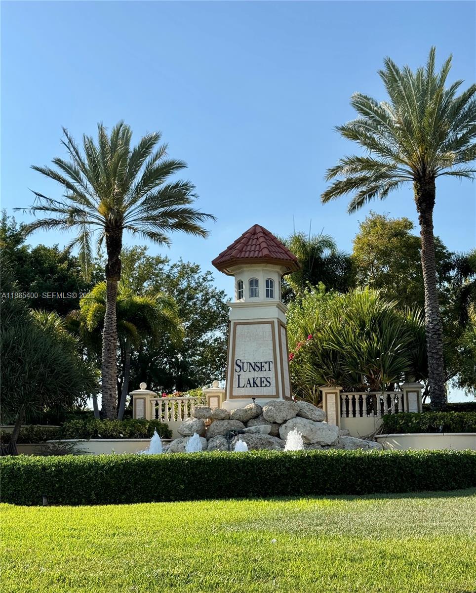 18991 Southwest 32nd Street Miramar, FL 33029 - Photo 92 of 98 a front view of a house with a garden