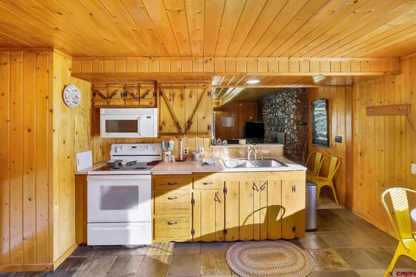 a kitchen with a sink appliances and cabinets
