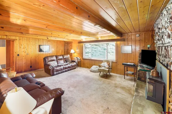 a bedroom with furniture and a flat screen tv