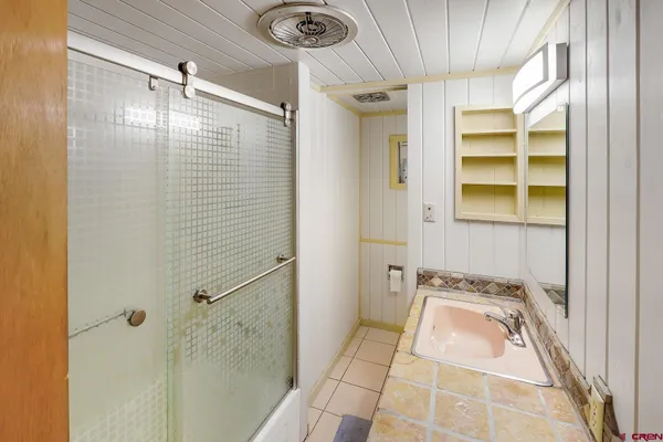 a bathroom with a sink and shower
