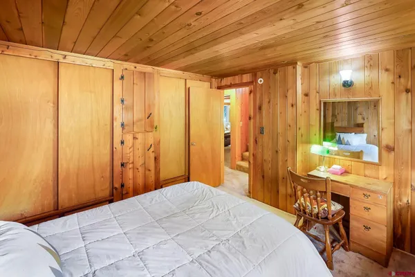 a bedroom with a bed and a table